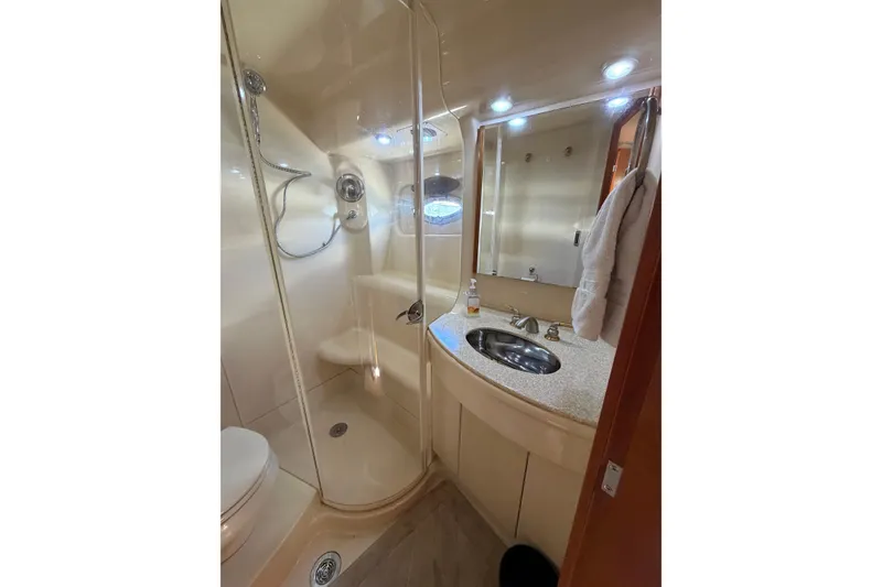 Slide: The Image of Luxurious bathroom in a 2004 Meridian 411 Sedan yacht, featuring a shower and vanity. - 21