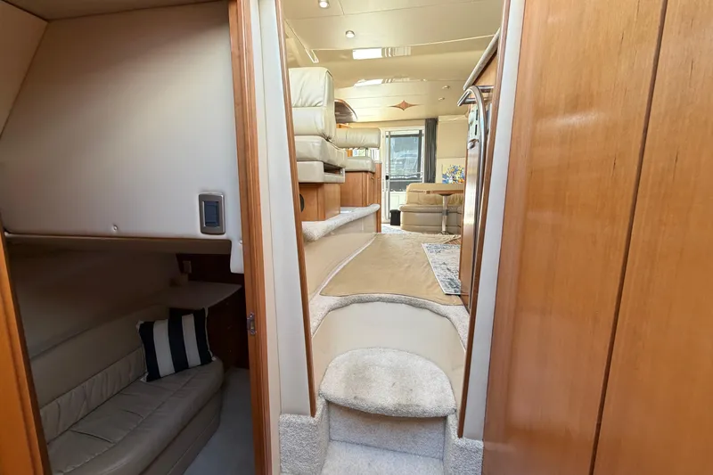 Slide: The Image of Interior of 2004 Meridian 411 Sedan yacht, featuring cozy seating and elegant wood finishes. - 23