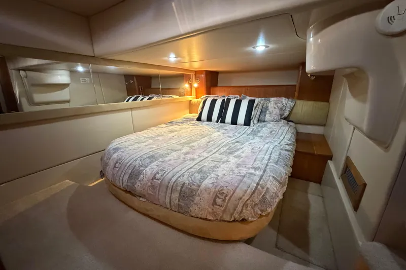 Slide: The Image of Luxurious bedroom interior of 2004 Meridian 411 Sedan yacht with cozy bedding. - 24