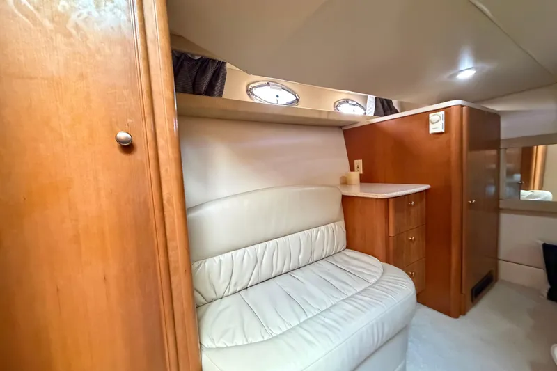 Slide: The Image of Luxurious interior of 2004 Meridian 411 Sedan with cream leather seating and wooden cabinetry. - 26