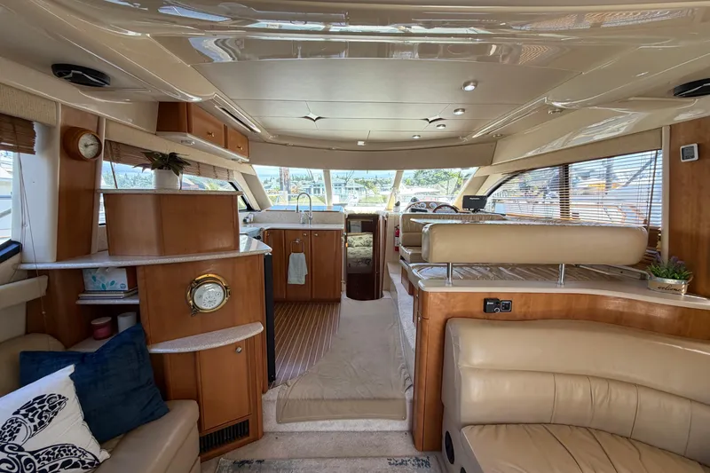 Slide: The Image of Interior of a 2004 Meridian 411 Sedan yacht with luxurious seating and wooden cabinetry. - 3