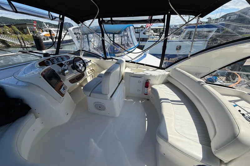 Slide: The Image of Interior view of a 2004 Meridian 411 Sedan yacht with helm and seating area. - 30