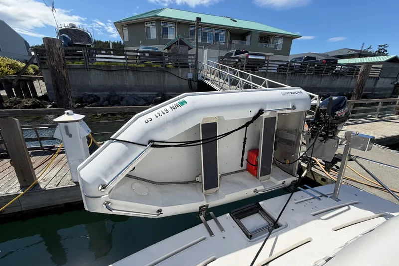 Slide: The Image of 2004 Meridian 411 Sedan docked with Suzuki outboard motor, near waterfront homes. - 35