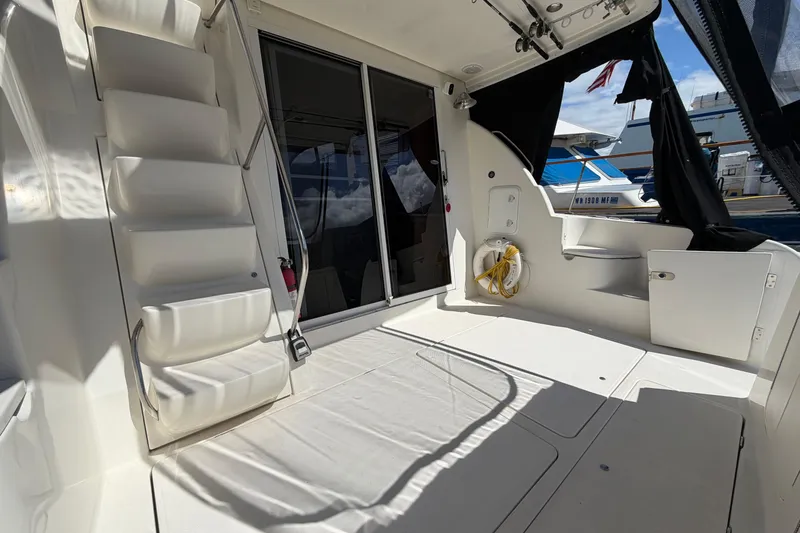 Slide: The Image of Spacious deck of 2004 Meridian 411 Sedan yacht with seating and storage. - 37