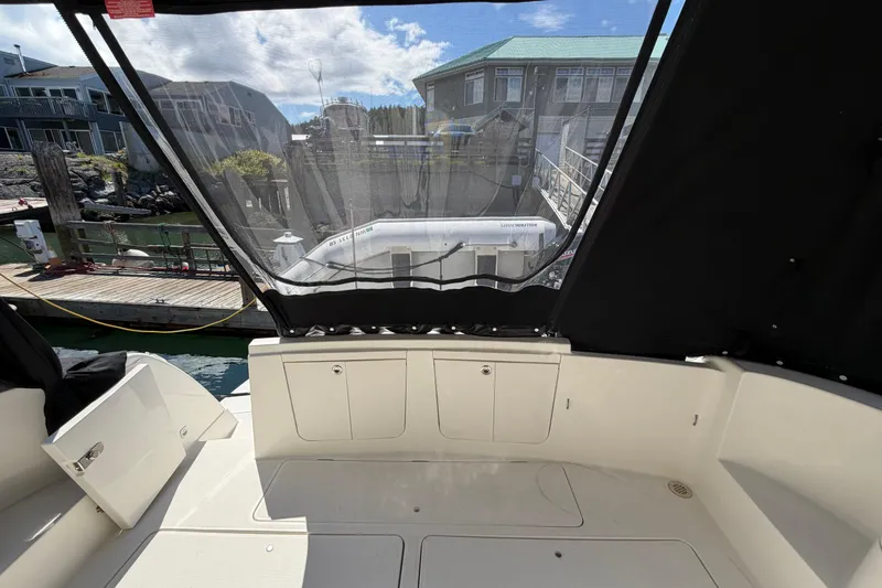 Slide: The Image of 2004 Meridian 411 Sedan yacht cockpit with marina view, featuring covered seating area. - 39