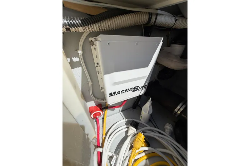 Slide: The Image of Electrical panel in a 2004 Meridian 411 Sedan boat, featuring wiring and a Magnesine unit. - 40