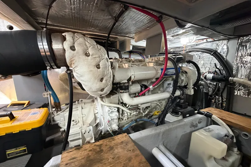 Slide: The Image of Engine room of a 2004 Meridian 411 Sedan yacht, showcasing detailed machinery and components. - 42