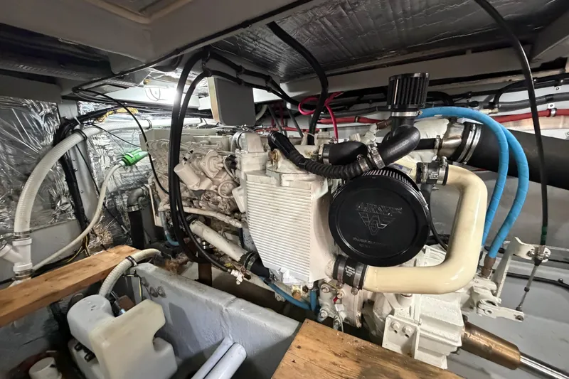 Slide: The Image of Engine room of a 2004 Meridian 411 Sedan yacht, showcasing detailed mechanical components. - 43