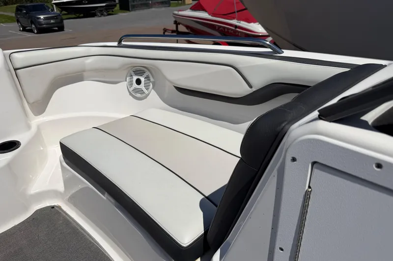 Slide: The Image of 2018 Yamaha Boats AR210 interior seating with speaker, showcasing sleek design and comfort. - 10