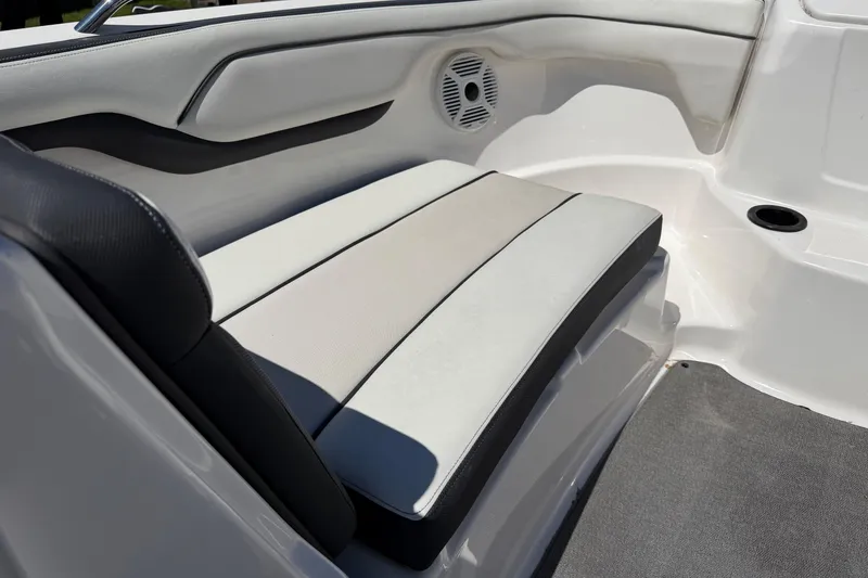 Slide: The Image of 2018 Yamaha Boats AR210 interior seating with speaker and cup holder. - 11