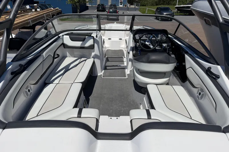 Slide: The Image of 2018 Yamaha Boats AR210 interior with spacious seating and modern dashboard design. - 4