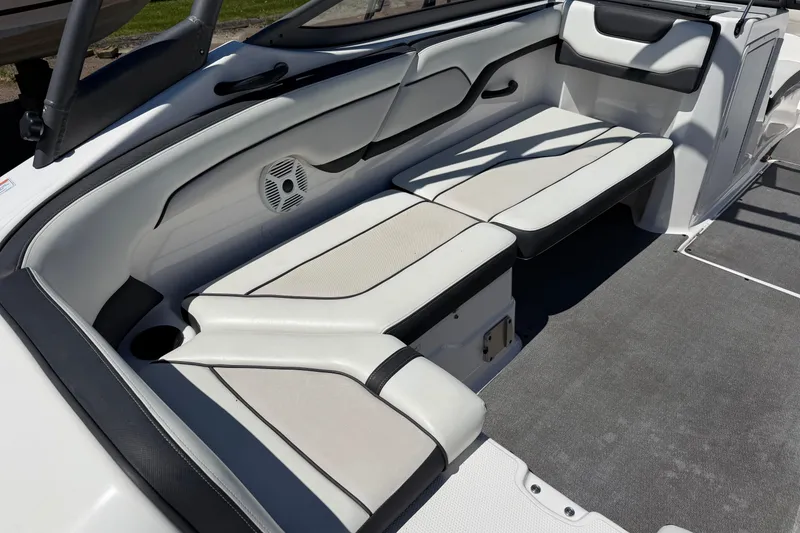 Slide: The Image of 2018 Yamaha Boats AR210 interior seating with white and black upholstery. - 6