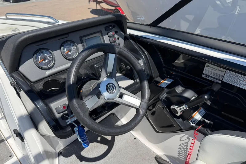 Slide: The Image of 2018 Yamaha AR210 boat dashboard with steering wheel and control panel. - 7
