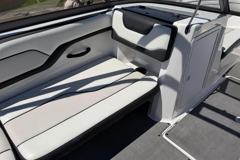 Slide: The Image of Interior seating of a 2018 Yamaha Boats AR210, featuring sleek white and black design. - 9