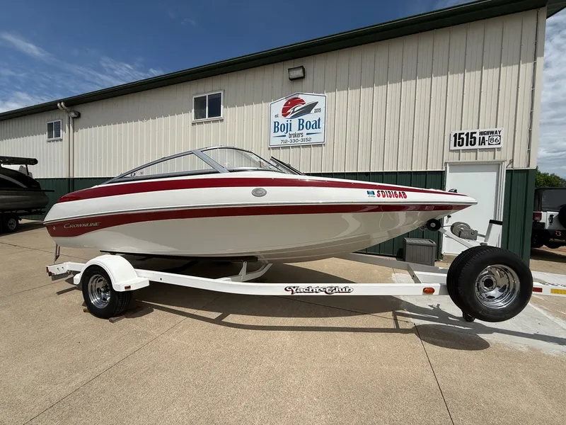 Slide: The Image of 2010 Crownline 180 BR boat on trailer outside warehouse. - 1