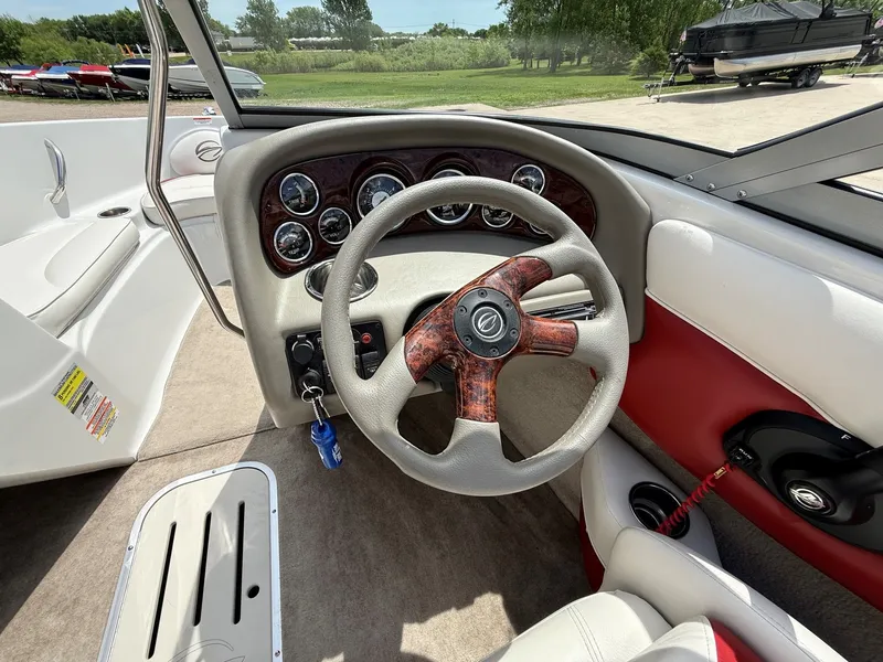 Slide: The Image of Interior view of a 2010 Crownline 180 BR boat with steering wheel. - 10