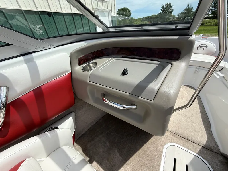 Slide: The Image of Interior of a 2010 Crownline 180 BR boat with red and white seating. - 11