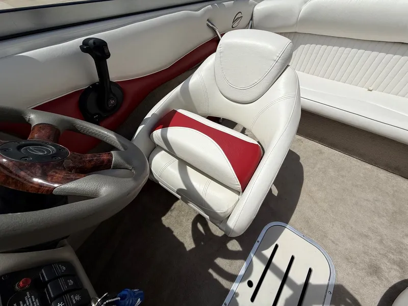 Slide: The Image of Interior of a 2010 Crownline 180 BR boat with steering wheel and seat. - 12