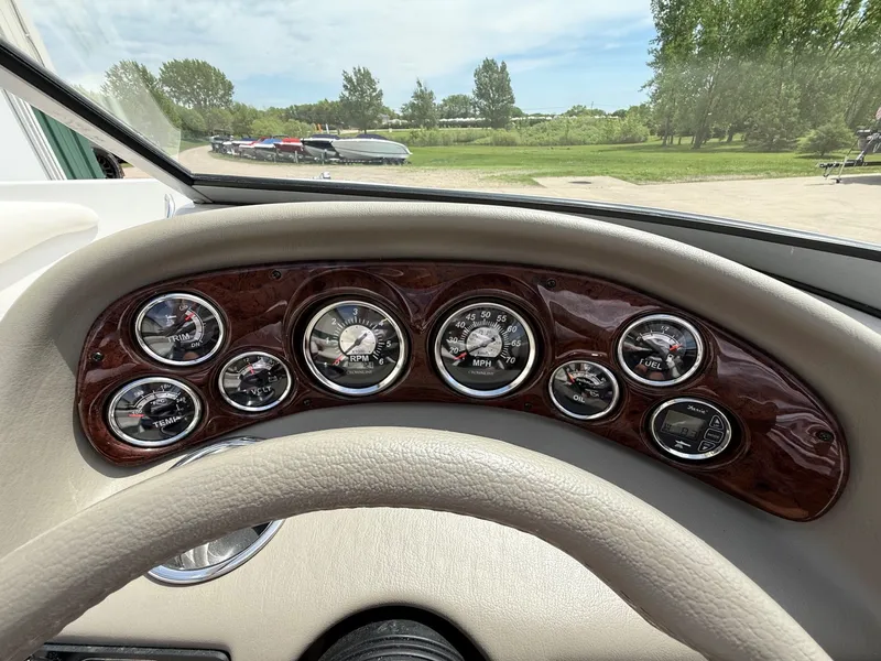 Slide: The Image of Dashboard of a 2010 Crownline 180 BR boat with gauges. - 16