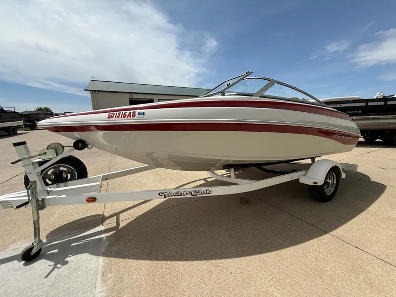 Slide: The Image of 2010 Crownline 180 BR boat on trailer outdoors. - 2