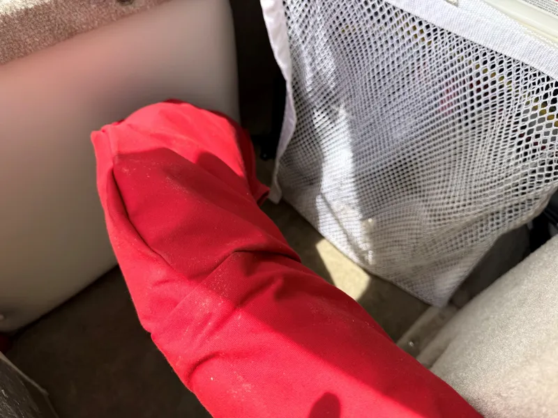 Slide: The Image of Interior of a Crownline 180 BR boat, red fabric and mesh pocket. - 21