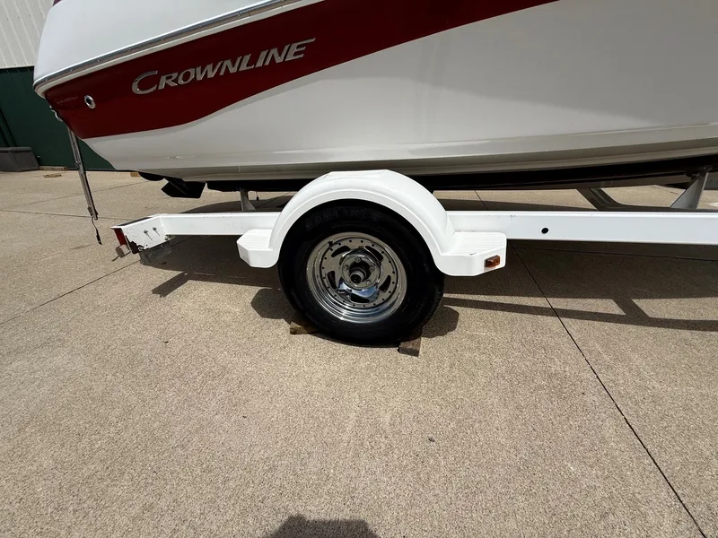 Slide: The Image of 2010 Crownline 180 BR boat on trailer, side view. - 23