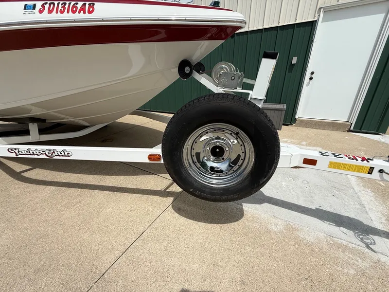 Slide: The Image of Crownline 180 BR 2010 on a boat trailer, close-up of the wheel. - 25