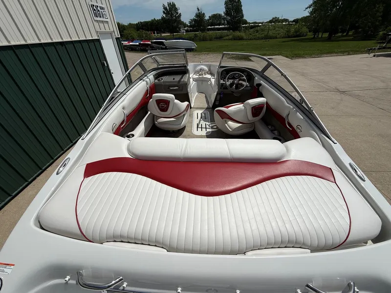 Slide: The Image of Interior of a 2010 Crownline 180 BR boat with red and white seating. - 8