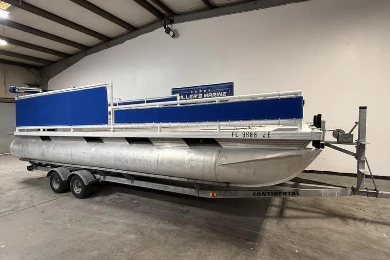 Slide: The Image of 1993 Monark Sun Caster 240 CR 4 Point pontoon boat on trailer in warehouse. - 1