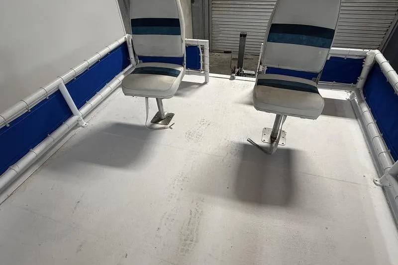 Slide: The Image of 1993 Monark Sun Caster 240 CR 4 Point boat interior with two swivel seats. - 10