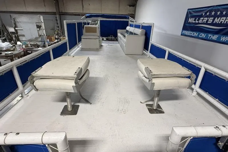 Slide: The Image of 1993 Monark Sun Caster 240 CR 4 Point pontoon boat interior with seating and blue accents. - 11