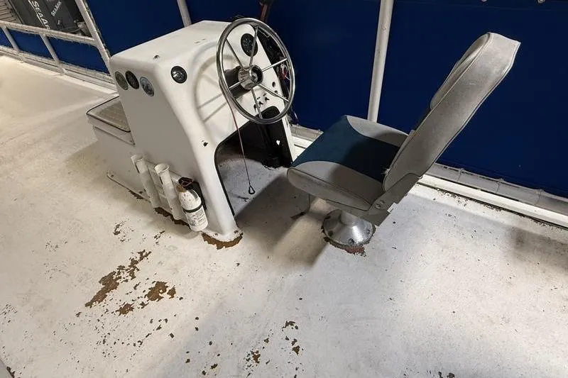 Slide: The Image of 1993 Monark Sun Caster 240 CR 4 Point boat helm with steering wheel and seat. - 6