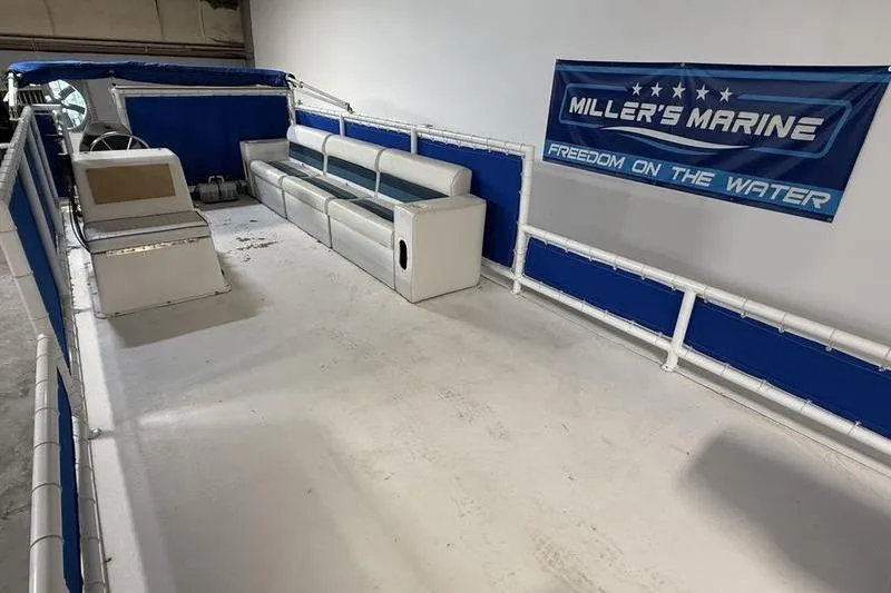 Slide: The Image of 1993 Monark Sun Caster 240 CR 4 Point pontoon boat interior with seating and steering console. - 7