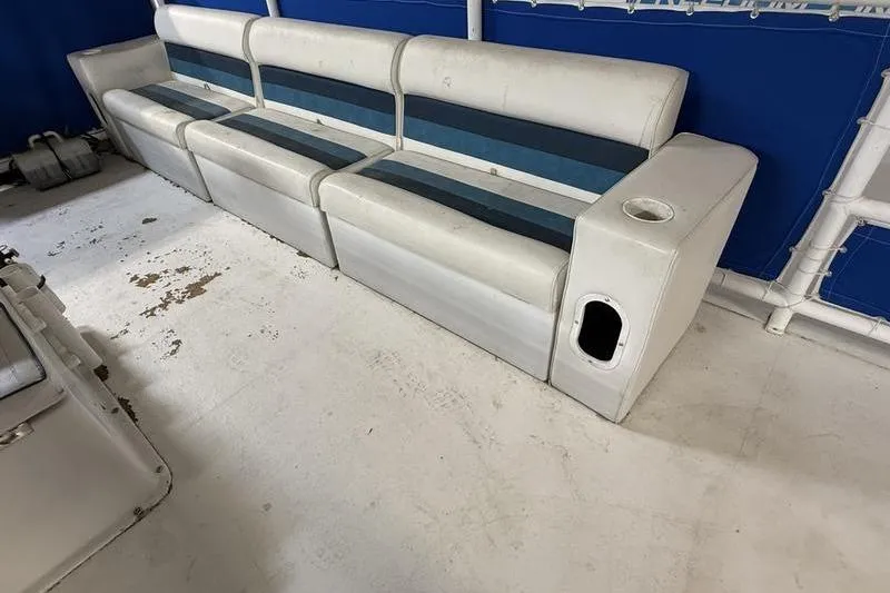 Slide: The Image of 1993 Monark Sun Caster 240 CR 4 Point boat seating with blue and white upholstery. - 8