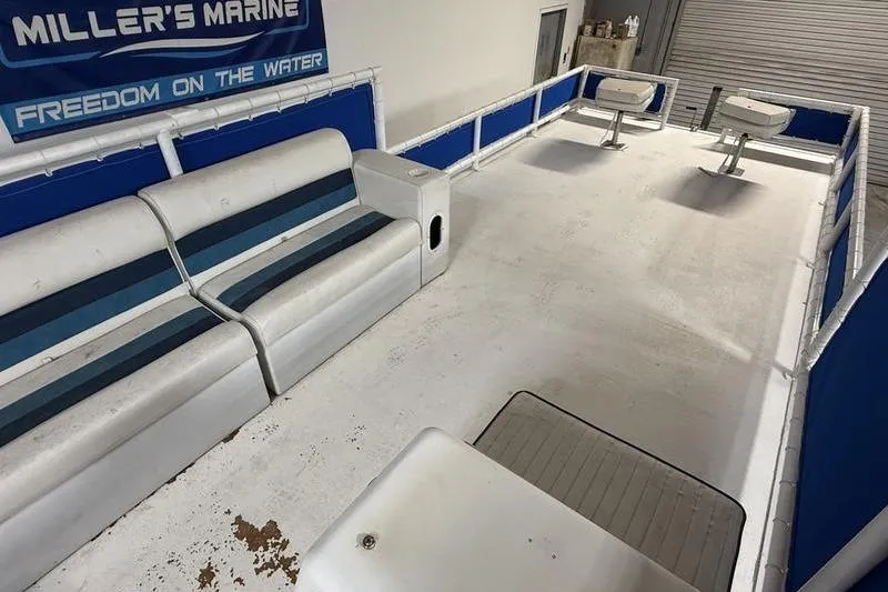 Slide: The Image of Interior of a 1993 Monark Sun Caster 240 CR 4 Point boat with seating and railing. - 9