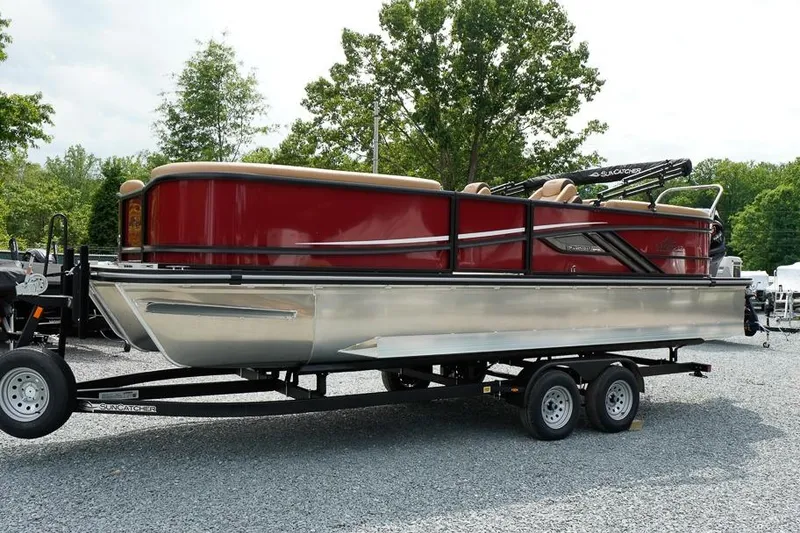 The Image of 2026 SunCatcher Fusion 324RC pontoon boat on trailer, parked outdoors. - 1