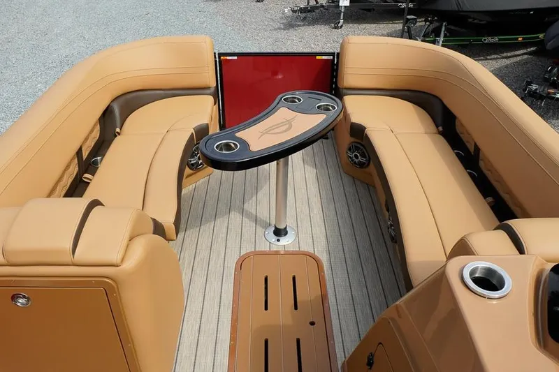 Slide: The Image of Luxurious seating area on 2026 SunCatcher Fusion 324RC boat with cup holders and table. - 16