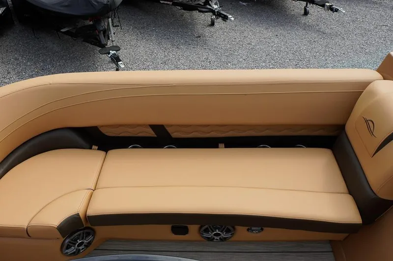 Slide: The Image of Luxurious tan seating on 2026 SunCatcher Fusion 324RC boat, featuring sleek design and integrated speakers. - 18