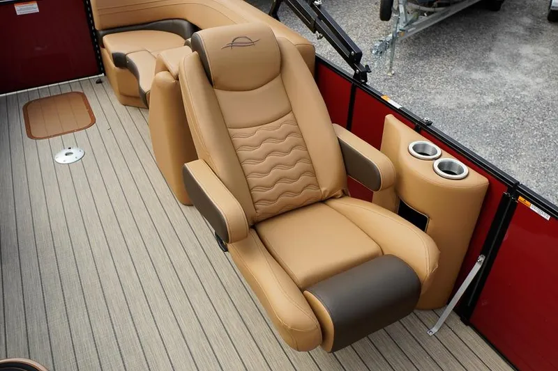 Slide: The Image of Luxurious seating on 2026 SunCatcher Fusion 324RC boat, featuring tan leather and cup holders. - 21