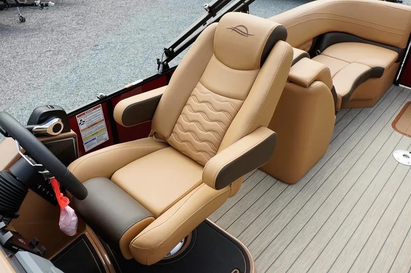 Slide: The Image of Luxurious seating in 2026 SunCatcher Fusion 324RC boat, featuring tan leather upholstery. - 23