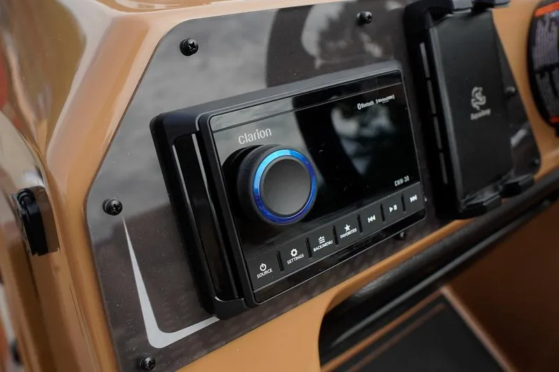 Slide: The Image of Dashboard of 2026 SunCatcher Fusion 324RC featuring a Clarion audio system. - 26