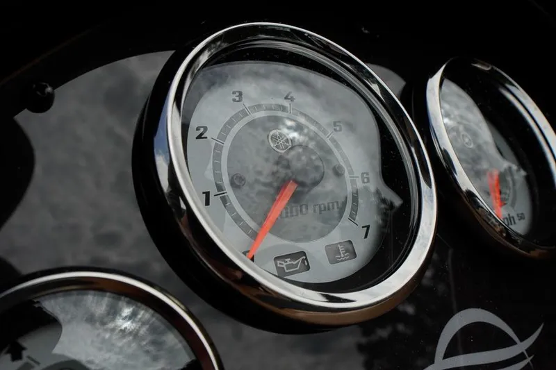 Slide: The Image of Close-up of SunCatcher Fusion 324RC 2026 dashboard gauges, showing RPM and oil indicators. - 28