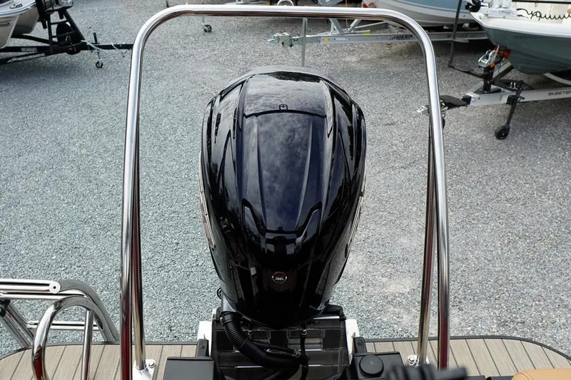 Slide: The Image of Outboard motor on 2026 SunCatcher Fusion 324RC boat, parked on gravel. - 35