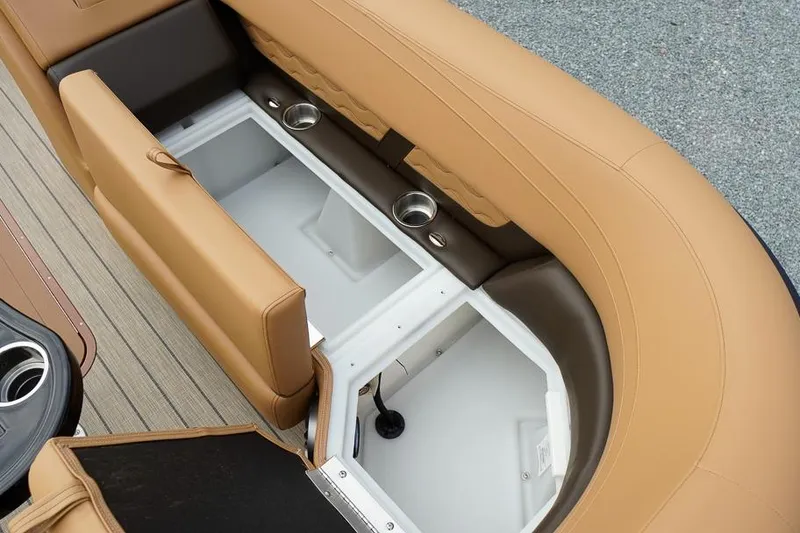 Slide: The Image of 2026 SunCatcher Fusion 324RC boat interior with tan seating and built-in storage compartments. - 38