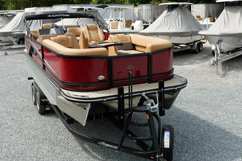 Slide: The Image of 2026 SunCatcher Fusion 324RC pontoon boat on trailer, featuring luxurious seating. - 4