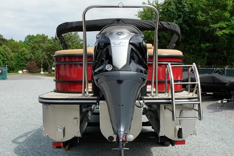 Slide: The Image of 2026 SunCatcher Fusion 324RC pontoon boat with powerful outboard motor, parked outdoors. - 5