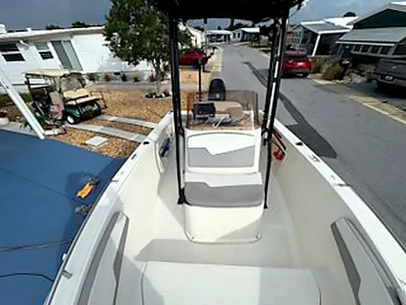 Slide: The Image of 2024 Caravelle Key Largo 1800 CC boat parked in residential area. - 3