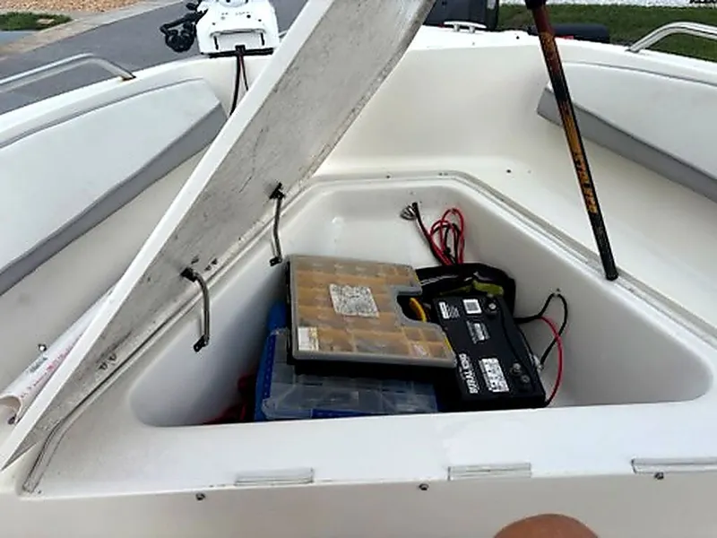 Slide: The Image of 2024 Caravelle Key Largo 1800 CC storage compartment with battery and accessories. - 8