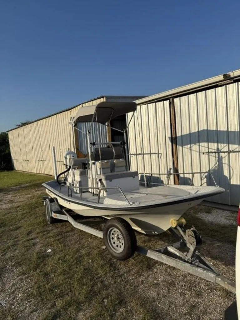 Slide: The Image of 1992 Gulf Coast GC20 boat on trailer near warehouse. - 2