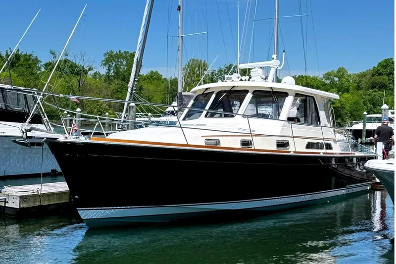 The Image of 2006 Sabre 38 Salon Express yacht docked in a marina on a sunny day. - 0